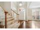 Bright foyer with hardwood floors, arched doorway, staircase and lots of natural light at 1574 Stepstone Way, Lawrenceville, GA 30043