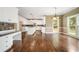 Elegant kitchen with granite counters, white cabinets, and hardwood floors at 1574 Stepstone Way, Lawrenceville, GA 30043