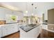 Modern kitchen with stainless steel appliances, granite countertops, and an island for food prep at 1574 Stepstone Way, Lawrenceville, GA 30043