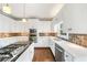 Modern kitchen with stainless steel appliances, updated countertops, and ample storage space at 1574 Stepstone Way, Lawrenceville, GA 30043