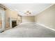 Spacious carpeted living room featuring a fireplace and sliding glass doors at 1574 Stepstone Way, Lawrenceville, GA 30043