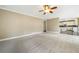 Open floor plan with carpeted living room with kitchen in the background at 1574 Stepstone Way, Lawrenceville, GA 30043