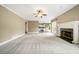 Spacious living room with fireplace and view into adjacent kitchen area at 1574 Stepstone Way, Lawrenceville, GA 30043