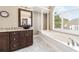 Bright main bathroom featuring a soaking tub and stylish vanity at 1574 Stepstone Way, Lawrenceville, GA 30043