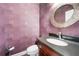 Elegant powder room featuring modern fixtures and stylish wallpaper at 1574 Stepstone Way, Lawrenceville, GA 30043