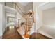 Staircase with carpeted steps, wood handrail, white banister, and hardwood landing at 1574 Stepstone Way, Lawrenceville, GA 30043