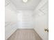 Practical walk-in closet with wire shelving units at 1574 Stepstone Way, Lawrenceville, GA 30043