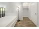 Clean bedroom with white walls, wood floors, closet, and a black standing lamp at 620 Peachtree Ne St # 503, Atlanta, GA 30308
