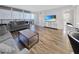 Bright living room with wood floors, modern furnishings, and access to a private balcony at 620 Peachtree Ne St # 503, Atlanta, GA 30308