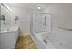 Bright bathroom with a glass enclosed shower and large soaking tub at 1735 Peachtree Ne St # 227, Atlanta, GA 30309