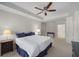 Bedroom features a ceiling fan, bedside table, and overlooks a hallway at 1735 Peachtree Ne St # 227, Atlanta, GA 30309