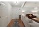 Bright hallway featuring hardwood floors, white walls, and neutral furnishings that leads into the cozy living room at 1735 Peachtree Ne St # 227, Atlanta, GA 30309