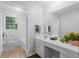 Bright bathroom featuring a modern vanity, large mirror, and a bathtub with shower at 2330 Bonnybrook Way, East Point, GA 30344