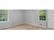 Bright bedroom with wood floors and windows letting in natural light at 2330 Bonnybrook Way, East Point, GA 30344