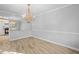 Elegant dining room featuring modern light fixture, light-colored flooring, and view into the kitchen at 2330 Bonnybrook Way, East Point, GA 30344