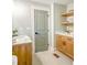 Neutral-toned bathroom featuring a modern sink with open shelf storage and a gray painted door at 642 Austin Se Dr, Smyrna, GA 30082