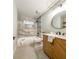 Well-lit bathroom with modern fixtures, vanity, and tiled shower and tub at 642 Austin Se Dr, Smyrna, GA 30082