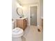 Bright bathroom with modern vanity, a round mirror and a gray painted door at 642 Austin Se Dr, Smyrna, GA 30082