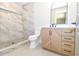 Bright bathroom featuring new toilet, sink, vanity and marble tiled shower at 642 Austin Se Dr, Smyrna, GA 30082