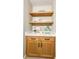 Close-up of custom bathroom storage unit with marble countertops, and rustic wood floating shelves at 642 Austin Se Dr, Smyrna, GA 30082