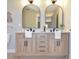 Stylish bathroom boasts a double vanity with marble countertop, arched mirrors, and modern fixtures at 642 Austin Se Dr, Smyrna, GA 30082