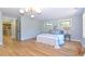Bright bedroom with hardwood floors, light blue walls, and a view into the kitchen area at 642 Austin Se Dr, Smyrna, GA 30082