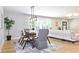Inviting dining room with hardwood floors, modern lighting, and a view into the living room at 642 Austin Se Dr, Smyrna, GA 30082