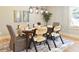 Inviting dining room boasts a stylish table setting and designer lighting at 642 Austin Se Dr, Smyrna, GA 30082
