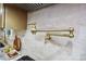 View of the brass pot filler faucet and tiled backsplash in kitchen at 642 Austin Se Dr, Smyrna, GA 30082