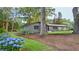 Well-maintained front yard with lush hydrangeas, mature trees and a charming home at 642 Austin Se Dr, Smyrna, GA 30082