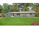 Beautiful house with an expansive lawn, decorative trellises, and manicured landscaping at 642 Austin Se Dr, Smyrna, GA 30082