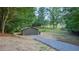 A backyard shed with a gravel driveway provides extra storage space on the property at 642 Austin Se Dr, Smyrna, GA 30082