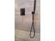 Contemporary matte black shower fixture with a sleek design set against the marble-style tiled shower wall at 642 Austin Se Dr, Smyrna, GA 30082
