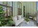 Relaxing covered balcony with outdoor furniture and green plants at 1408 Cozy Court # 303, Atlanta, GA 30315