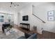 Bright living room featuring modern furnishings, wood floors, and a staircase with wood railing at 1408 Cozy Court # 303, Atlanta, GA 30315