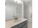 Modern bathroom featuring a quartz countertop, gray cabinetry, and a tub with tile surround at 325 Sassafras W Way, Holly Springs, GA 30115