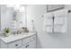 Bright bathroom featuring a modern vanity with stone countertop and bronze hardware at 325 Sassafras W Way, Holly Springs, GA 30115