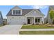Charming one-story home with a two-car garage, well-manicured lawn, and inviting front porch at 325 Sassafras W Way, Holly Springs, GA 30115