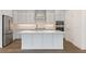 Modern kitchen with stainless steel appliances, quartz countertops, and center island at 325 Sassafras W Way, Holly Springs, GA 30115