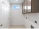 Functional laundry room with overhead cabinets and ample storage space at 325 Sassafras W Way, Holly Springs, GA 30115