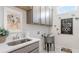 Charming laundry room featuring custom cabinets, modern appliances, and stylish decor at 325 Sassafras W Way, Holly Springs, GA 30115