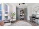 Cozy living room features a neutral palette, area rug, and natural lighting at 325 Sassafras W Way, Holly Springs, GA 30115