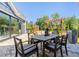 Outdoor patio featuring dining table and chairs, trellis with hanging plants, and a view of backyard at 325 Sassafras W Way, Holly Springs, GA 30115