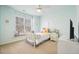 Light and airy bedroom with a cozy window seat and neutral carpet at 586 Devon Brooke Dr, Woodstock, GA 30188