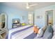 Bright bedroom featuring blue walls, striped bedding, and a fun, beachy theme decor at 586 Devon Brooke Dr, Woodstock, GA 30188