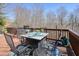 Outdoor deck with dining table and chairs ready for entertaining at 586 Devon Brooke Dr, Woodstock, GA 30188