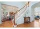 Light-filled foyer with hardwood floors and staircase leading to the upper level at 586 Devon Brooke Dr, Woodstock, GA 30188