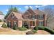 Elegant brick residence boasting a symmetrical facade and inviting front porch at 586 Devon Brooke Dr, Woodstock, GA 30188