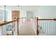 Hallway upstairs showing decorative woodwork and view of lower level and fireplace at 586 Devon Brooke Dr, Woodstock, GA 30188