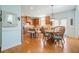 Charming kitchen with wooden cabinets, central island with stools, and adjacent dining area with natural light at 586 Devon Brooke Dr, Woodstock, GA 30188